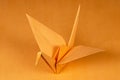 Orange origami crane tsuru on orange background