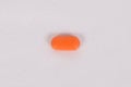 Orange oval pill isolated on white background