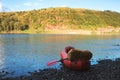 Orange packraft rubber boat with backpack on a river