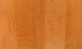 Orange paint on aged wall surface Royalty Free Stock Photo