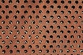 Orange painted circle perforated metal panel for texture and background Royalty Free Stock Photo