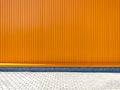 Orange painted corrugated metal warehouse wall. modern storage building facade Royalty Free Stock Photo