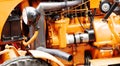 Orange-painted engine compartment of a vintage tractor