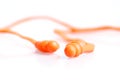 Orange pair of earplugs industrial equipment isolated on white Royalty Free Stock Photo
