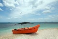 Orange panga / fishing boat on coral beach in Sri Lanka Royalty Free Stock Photo