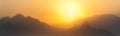 Orange panorama - misty mountains at sunset