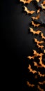 Orange paper bats on the black background. Vertical banner with copy space. Generated AI Royalty Free Stock Photo