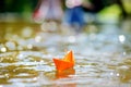 Orange paper boat with a white flag Royalty Free Stock Photo