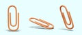 Orange paper clip. Office supplies. Accessory for fastening paper sheets