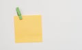 Orange paper notes fastened with a wooden clothespin on a white background Royalty Free Stock Photo