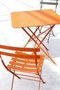 Orange patio chair and table with shadow Royalty Free Stock Photo