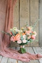 Orange peach bouquet with eucalyptus roses carnations on wooden background. March 8 congratulations Royalty Free Stock Photo