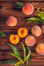 Orange peaches with green leaves on the wooden background. Sliced fruit, copy space, top view flat lay Royalty Free Stock Photo