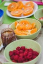 Orange peeled slices in bowls, party table Royalty Free Stock Photo