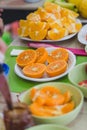 Orange peeled slices in bowls, party table Royalty Free Stock Photo