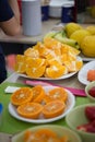 Orange peeled slices in bowls, party table Royalty Free Stock Photo