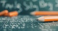 Orange Pencil on Black Chalkboard With Math Equations at a Study Session Royalty Free Stock Photo