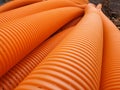 Orange perforated drainage pipe, corrugated.