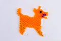 Orange perler bead dog.