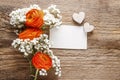 Orange persian buttercup flower and baby`s breath on wood Royalty Free Stock Photo