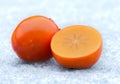 Orange persimmon fruit on the ice.