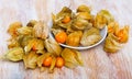 Orange physalis fruit on wooden desk