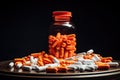 Orange pills and bottle on a black background. Focus on foreground, Prescription opioids with many bottles of pills in the