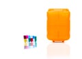 Orange pills box with colorful capsule pills on white background with copy space