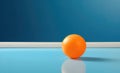 Orange ping pong ball on a blue tennis table with copy space