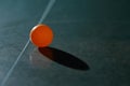 Orange ping pong ball on a green table Royalty Free Stock Photo