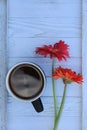 Orange and pink Gerbera Daisy flowers and coffee mug Royalty Free Stock Photo