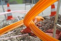 Orange pipes for fiber optics in a large city road construction Royalty Free Stock Photo