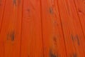 Orange plank wood texture background. Close up of painted wooden fence panels Royalty Free Stock Photo