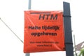 Orange plastic bag around tram stop sign due to temporary closing of the stop by HTM in The Hague.