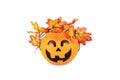 Orange plastic basket halloween pumpkin with wreath of autumn maple leaves atop, isolated on white Royalty Free Stock Photo