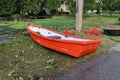 Orange Plastic Boats Small Boats For Water Traffic parked on the outdoor floor