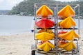 Orange Plastic canoe boat put in metal rack storage on the beach. Royalty Free Stock Photo