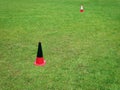 Orange Plastic Cones in Green Grass Soccer Field for Sport Training Royalty Free Stock Photo