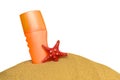 Orange plastic container on the sand with a red starfish. Royalty Free Stock Photo