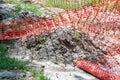 Orange plastic safety net or barrier on the street to protect excavating construction site close up Royalty Free Stock Photo