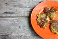 Orange Plate On Wooden Table Full Of Cauliflower And Broccoli Pancakes