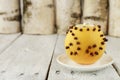 Orange pomander ball with candle on wooden table Royalty Free Stock Photo