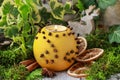 Orange pomander ball with candle on wooden table Royalty Free Stock Photo