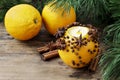 Orange pomander ball with candle on wooden table Royalty Free Stock Photo