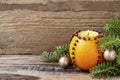 Orange pomander ball with candle on wooden table Royalty Free Stock Photo