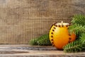 Orange pomander ball with candle on wooden table Royalty Free Stock Photo