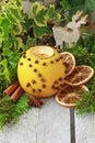 Orange pomander ball with candle on wooden table Royalty Free Stock Photo