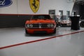 Orange Pontiac Firebird seen from the front standing in a garage.