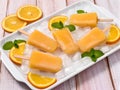 Homemade ice-cold orange popsicles on crushed ice Royalty Free Stock Photo