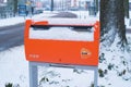 Orange postbox in snow